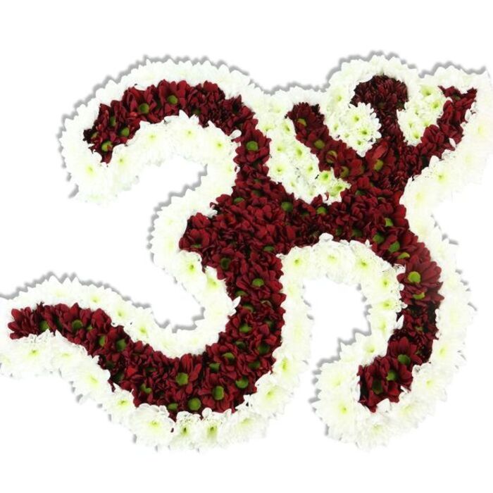The sacred Om (Aum) is rendered here as a lavish floral icon: densely grouped maroon and burgundy chrysanthemum-like blooms form the core, their small lime-green centers peeking through like notes of living contrast. Encircling and tracing every inner curve is a broad band of immaculate white spray chrysanthemums, a border that not only clarifies the Sanskrit form but also lends the piece a radiance that reads as purity and calm. The flowers are packed so tightly their individual petals blend into a velveteen plane, yet the craftsmanship remains evident in the crispness of each contour and the careful shaping of the symbol's distinctive '3' curve, the elongated lower stroke, and the crescent-and-dot composition above. A soft, realistic shadow beneath the arrangement gives the work dimensionality against the plain white background, making it suitable as a ceremonial focal point or photographic subject. Sensory details hover at the edges of sight: an understated, earthy aroma like a late-summer garden, a coolness you would feel brushing the petals, and the visual hush that invites quiet reflection. This arrangement speaks directly to rites of remembrance, devotional gatherings, and meditative spaces - an artful floral mantra that would sit respectfully on an altar at a community event in Epping or as a dignified tribute during a memorial service near the High Street or at a nearby temple. The overall impression is one of devotion, meticulous floral technique, and tranquil beauty.